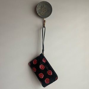 Coach black and floral wristlet.